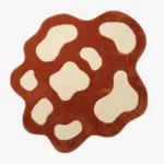 Full top-down view of the custom-shaped Terra Pop rug isolated on a white background, featuring an abstract spotted pattern in solid terracotta orange and off-white.