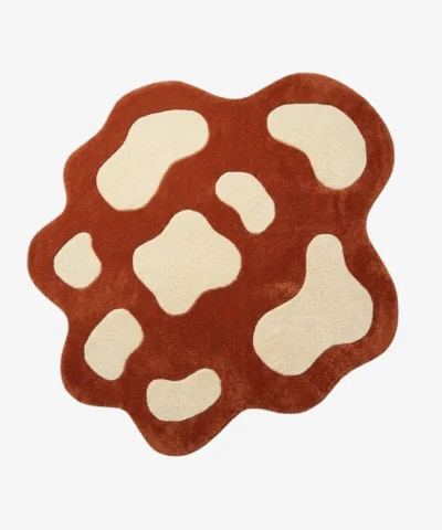 Full top-down view of the custom-shaped Terra Pop rug isolated on a white background, featuring an abstract spotted pattern in solid terracotta orange and off-white.