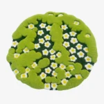 Full top-down product isolated shot of the round, irregularly shaped Terrain Bloom rug featuring 3D moss green tufted borders over a daisy floral pattern.