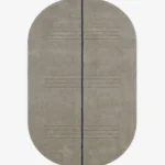 Full top-down product isolated shot of the oval-shaped Urban Meridian area rug in a muted taupe grey pile, bisected by a single dark charcoal linear element and subtle horizontal etched accent lines.