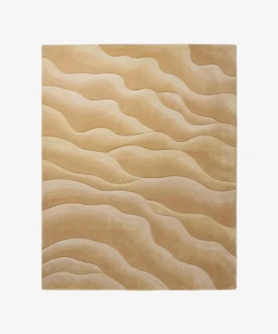Full top-down product isolated shot of the rectangular Velune Wave area rug, featuring an organic, monochromatic undulating wave pattern in concentric layered shades of warm beige, camel, sand, and cream.