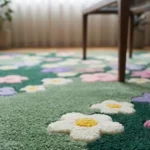 Low angle close-up floor perspective showcasing the plush pile depth, crisp solid color blocks, and scattered white and yellow daisy-style flowers of the Wildflower Meadow rug.
