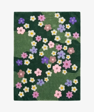 Full top-down product isolated shot of the rectangular Wildflower Meadow area rug featuring a multi-toned green field adorned with scattered retro flower motifs in pink, purple, brown, and cream.