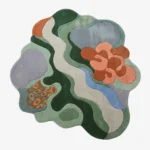 Full top-down product isolated shot of the uniquely shaped Wildgrove abstract rug featuring organic fluid shapes in green, blue, lavender, and terracotta tones.