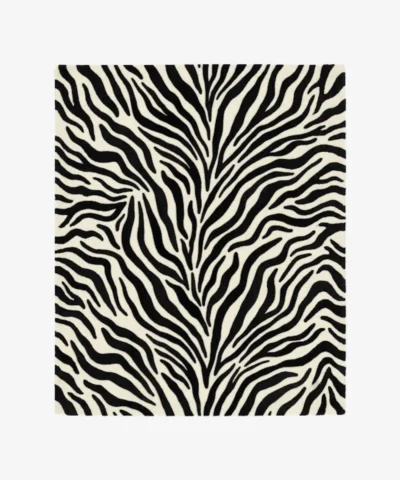 A top-down studio product photograph of a rectangular area rug featuring a classic black-and-white zebra animal print pattern on a clean background.