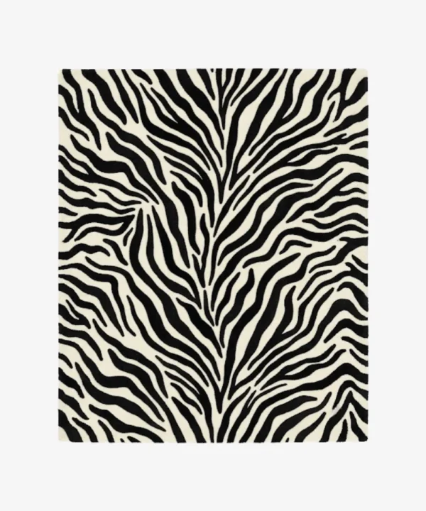 A top-down studio product photograph of a rectangular area rug featuring a classic black-and-white zebra animal print pattern on a clean background.