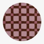 Full top-down product isolated shot of the round Blush Quadra area rug, featuring a retro checkered grid pattern with large blush pink blocks, darker mauve pink intersection squares, and deep chocolate brown grid lines.