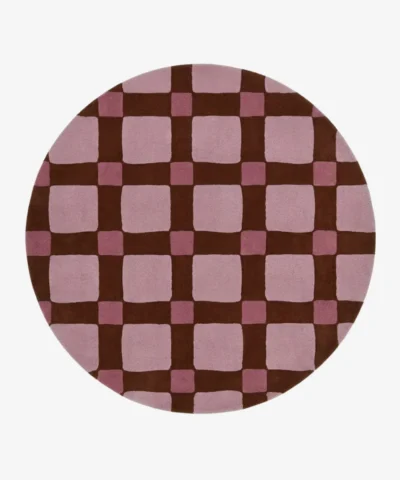 Full top-down product isolated shot of the round Blush Quadra area rug, featuring a retro checkered grid pattern with large blush pink blocks, darker mauve pink intersection squares, and deep chocolate brown grid lines.