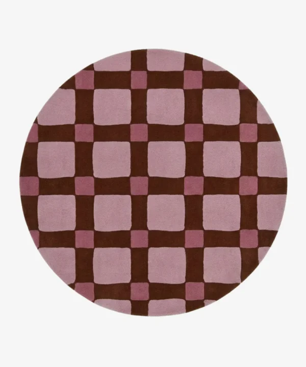 Full top-down product isolated shot of the round Blush Quadra area rug, featuring a retro checkered grid pattern with large blush pink blocks, darker mauve pink intersection squares, and deep chocolate brown grid lines.