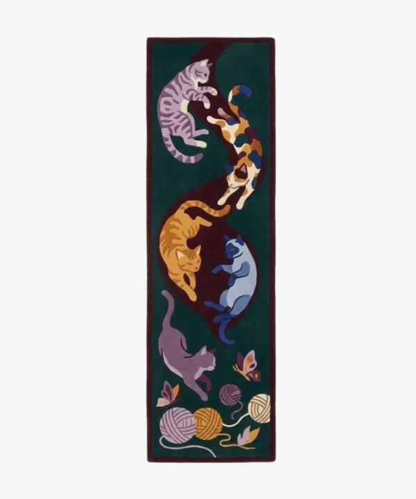 Full top-down product isolated shot of the long rectangular Cat Harmony hallway runner rug, featuring five playful illustrated kittens, butterflies, and textured yarn balls in solid shades of orange, purple, calico, and blue across a deep forest green and maroon background field.