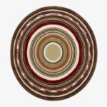 A top-down studio product photograph of a round area rug featuring concentric circular patterns in rich tones of chestnut, deep red, cream, and purple, displayed on a clean background.
