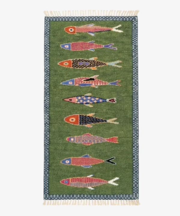 A top-down studio product shot of the green rectangular runner rug with a vertical sequence of diverse, colorful, hand-knotted fish illustrations.