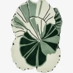 Full top-down product isolated shot of the custom-shaped Green Sanctuary area rug, featuring an organic abstract monstera or palm leaf silhouette with overlapping layers of deep forest green, sage green, and an off-white background field with thin black line detailing.