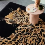 Leobra leopard tufted modern area rug styled in an interior room setting next to decor.