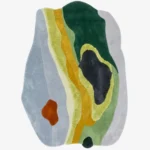 Full top-down isolated product shot of the custom irregular-shaped Lichen Flow area rug, showcasing a multi-textured abstract moss landscape design with organic blocks of forest green, chartreuse yellow, slate grey, sage, and a small terracotta orange accent patch.