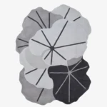 Full top-down product isolated shot of the custom-shaped Lotus Canopy area rug, featuring overlapping organic lotus leaf contours with prominent dark grey veining across a monochromatic palette of off-white, light grey, and charcoal.