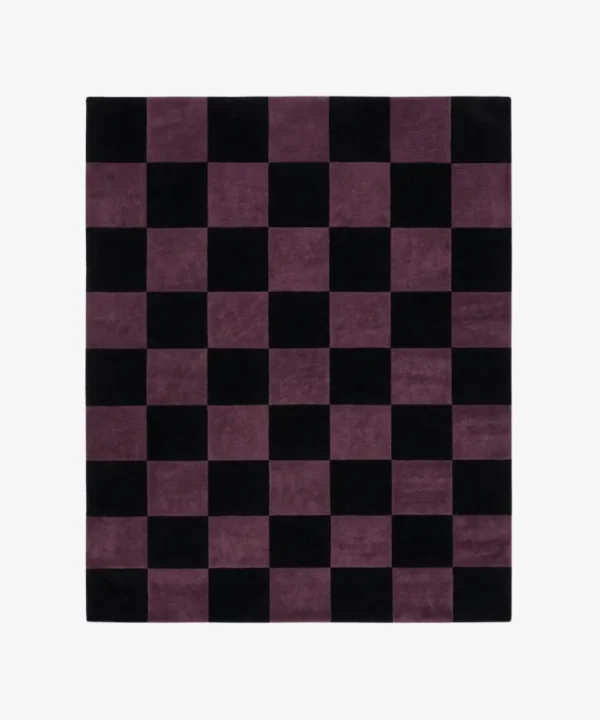 A top-down studio product photograph of a rectangular area rug featuring a classic checkered pattern in mulberry purple and black.