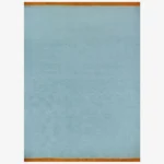 A full top-down studio shot of the rectangular Nimbus area rug, featuring a solid sky-blue wool pile with a contrasting vibrant orange fringed border on both short ends.