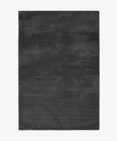 A top-down studio product photograph of a solid dark gray onyx area rug displayed against a neutral background.