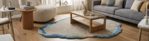 Modern organic shaped area rug with fluid blue and neutral tones styled in a contemporary living room.