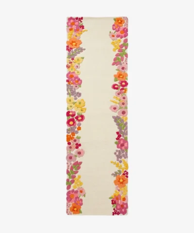 A full top-down studio product photograph of the Rosalia runner rug, featuring a creamy off-white base with intricate, vibrant, multi-colored floral borders.