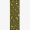 A top-down studio product photograph of the rectangular Sage Koi runner rug, showcasing the dense green pile and the scattered arrangement of stylized koi fish motifs.