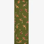 A top-down studio product photograph of the rectangular Sage Koi runner rug, showcasing the dense green pile and the scattered arrangement of stylized koi fish motifs.