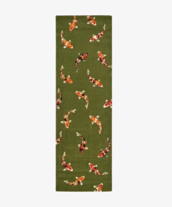 A top-down studio product photograph of the rectangular Sage Koi runner rug, showcasing the dense green pile and the scattered arrangement of stylized koi fish motifs.