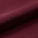 A macro close-up of the Sangria rug, focusing on the dense, luxurious, and soft-touch texture of the deep red wool pile.