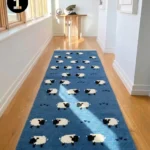 Interior hallway view of a blue Sleep Sheep runner rug with fringed ends, styled on hardwood flooring between white walls.