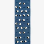 Top-down product shot of a rectangular blue wool runner rug featuring a playful, repeating pattern of white and black sheep and small dark heart motifs.