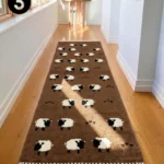 Interior hallway perspective of a brown Sleep Sheep wool runner rug with white fringe, displayed on wooden flooring in a modern home.