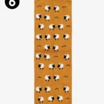 Top-down studio shot of a mustard-yellow wool runner rug featuring a whimsical pattern of black and white sheep and heart motifs.