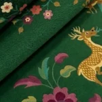 Close-up of the detailed tufted pile texture, plush wool feel, and intricate floral and deer patterns on the Verdanis rug.
