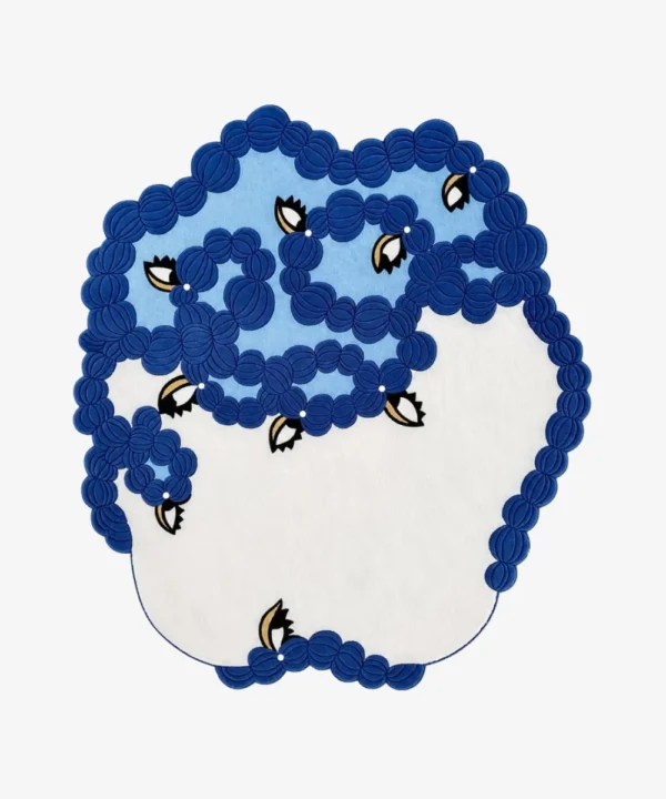 Amora blue floral organic shaped tufted area rug featuring interconnected blue floral patterns and white color blocking, displayed flat.