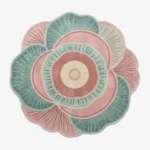 Palestra floral-shaped tufted area rug featuring concentric circles and petal patterns in pink, teal, and cream, displayed flat.