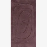 Plumique Basin dusty plum rectangular tufted area rug featuring carved concentric oval topographic rings, displayed flat.