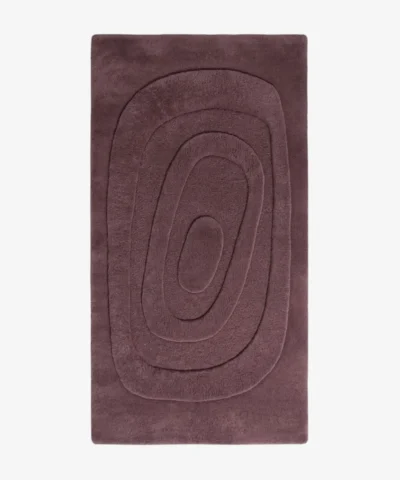 Plumique Basin dusty plum rectangular tufted area rug featuring carved concentric oval topographic rings, displayed flat.