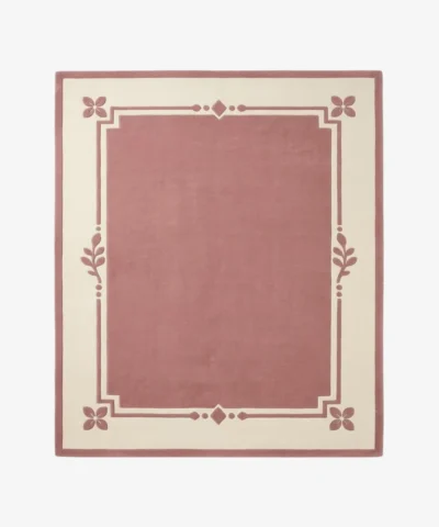 Rosaine pink and cream rectangular area rug featuring an elegant bordered geometric and floral corner design, displayed flat.
