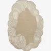 Flat-lay top view of the Tidewave designer wavy border rug showcasing its abstract shape and neutral earth tones.