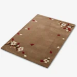 Angled studio product view of the rectangular Cherrywood Bloom rug, displaying the warm brown field adorned with scattered cherry blossom branches and falling petals.