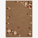 Studio flat-lay product photograph of the rectangular Cherrywood Bloom rug on a clean background, showcasing the full brown wool field framed by blooming cherry branches and floating petals.