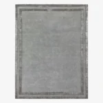 Studio flat-lay product photograph of the rectangular Gray Edge rug on a clean background, showcasing the solid grey wool field framed by double contrasting metallic silver borders.