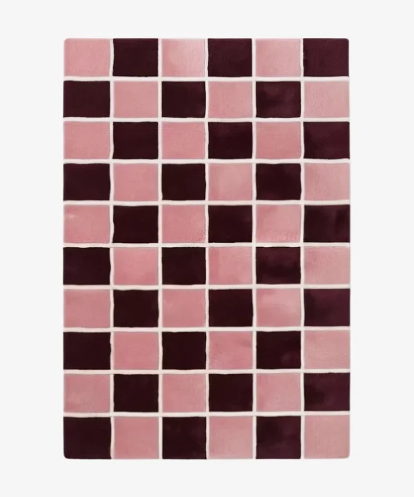 Angled studio product view of the rectangular Maroon Matrix rug, highlighting its modern checkered pattern featuring deep maroon and soft pink squares separated by clean white grout lines.