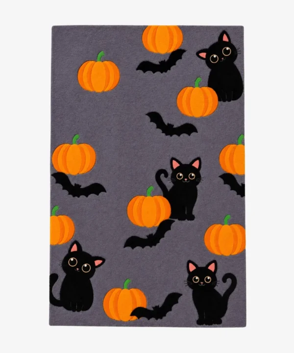 Studio flat-lay product photograph of the rectangular Paws & Pumpkins rug on a clean background, showcasing the grey wool field patterned with cute black cats, orange pumpkins, and flying bats.