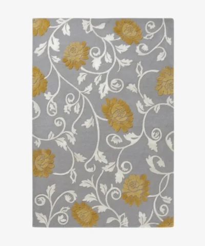 Studio flat-lay product photograph of the rectangular Twine rug on a clean background, showcasing the grey wool field patterned with flowing white botanical vines and mustard-gold floral blooms.