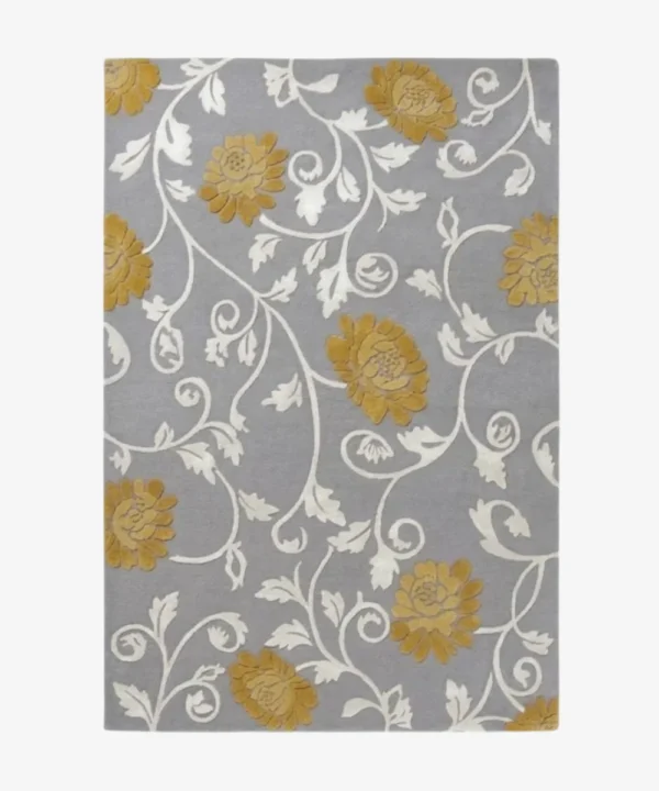 Studio flat-lay product photograph of the rectangular Twine rug on a clean background, showcasing the grey wool field patterned with flowing white botanical vines and mustard-gold floral blooms.
