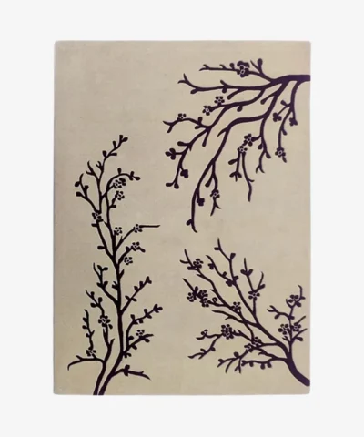 Studio flat-lay product photograph of the rectangular Wild Vine rug on a clean background, showcasing the neutral beige wool field patterned with elegant climbing dark vine branches and blossoms.